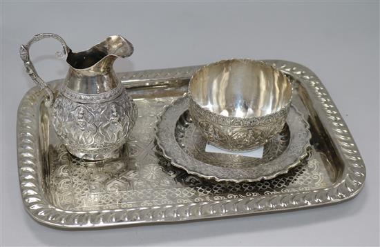 An Indian white metal jug and sugar bowl, a dressing table tray and a small dish